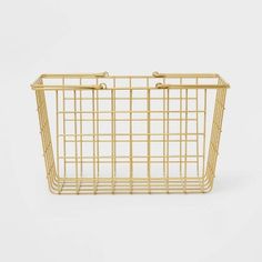 a gold wire basket with handles on the front and side, against a white background