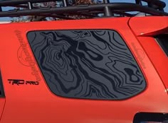 an orange sports utility vehicle parked on the street