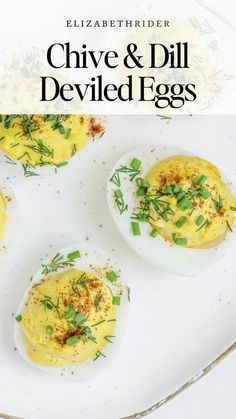 deviled eggs with chive and dill on them are served on a white plate