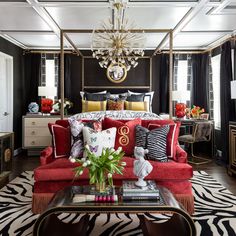 a living room filled with furniture and a chandelier hanging over the top of it