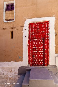 a red door on the side of a building