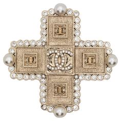 Chanel 2000s CC rhinestone-embellished cross brooch featuring gold-plated hardware, a cross motif, a signature interlocking CC logo, rhinestone embellishment, faux-pearl embellishment, a pin fastening, a back plaque. Circa 2000s . Made in France Length: 1.96in. (5cm) Width: 1.96in. (5cm) Excellent vintage condition. Made in France. We guarantee you will receive this gorgeous item as described and showed on photos. Chanel 2000s, Sophie's Choice, Cross Brooch, Pearl Embellishment, Gold Brooch, Shopping Chanel, Gold Brooches, A Cross, Cc Logo