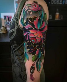 a woman with a colorful flower tattoo on her arm