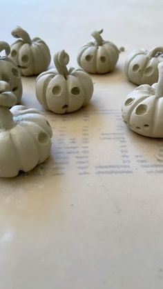 some white pumpkins sitting on top of a table