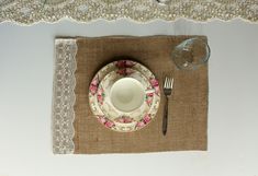 the place setting is ready to be served on the table for two people, including an empty plate and silverware