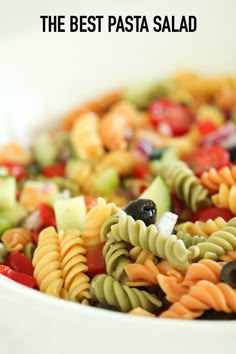 a white bowl filled with pasta and veggies