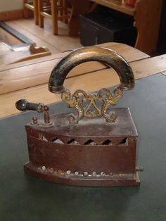 an old fashioned iron on top of a table