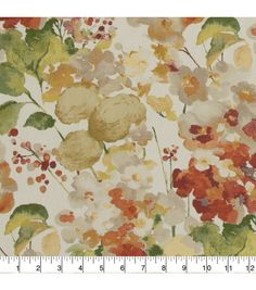 an image of a flower pattern on white fabric with orange and yellow flowers in the background