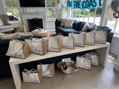 a living room filled with lots of bags on top of a table