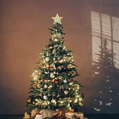 a small christmas tree with presents under it