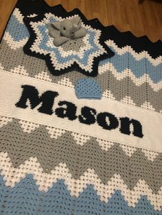 there is a crocheted blanket with the name mason on it and a teddy bear