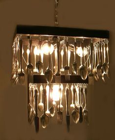 a chandelier with forks and spoons hanging from it