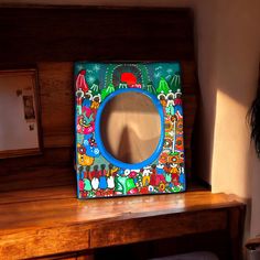 a mirror sitting on top of a wooden desk