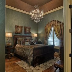 a bedroom with a chandelier hanging from the ceiling and a bed in it