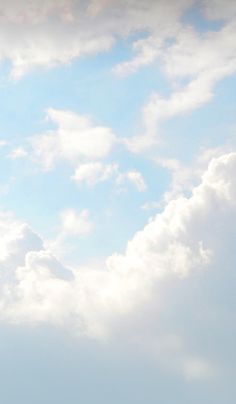 two airplanes flying in the sky on a cloudy day with blue skies and white clouds