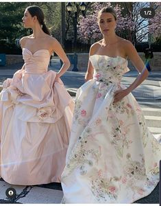 two women in dresses standing next to each other