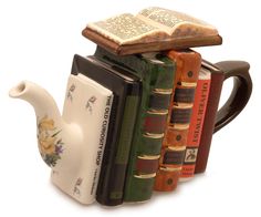 a stack of books with a teapot and bookend on top of each other