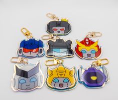 six cartoon key chains with different designs on them