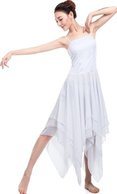 a woman in a white dress is dancing