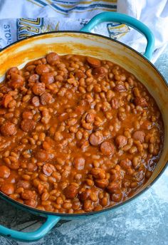 a pot filled with baked beans on top of a table