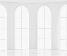 an empty white room with three arched windows