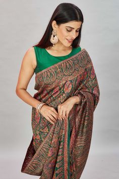 The elegance of this bottle green heavy Kani weave sari is sure to leave everyone awestruck! It comes with a matching blouse piece. Disclaimer: The shown stitched blouse on the model is for display purpose only. The saree comes with a matching blouse piece and finished with fall and piko.