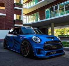 a blue car parked in front of a building