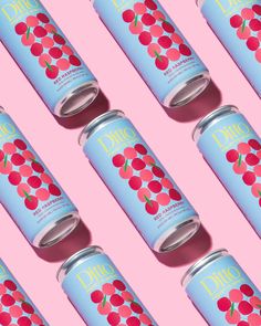 six canisters with cherries on them against a pink background