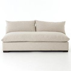 a white couch with two pillows on it