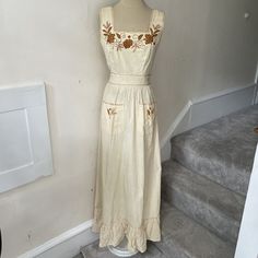 Vintage 1970s Beige Cotton Prairie Cottagecore Floral Embroidered Maxi Dress XS. Gorgeous vintage prairie cottagecore style maxi dress from the late 1960s/early 1970s from the hippie bohemian era. Has gorgeous floral embroidery throughout. Two front pockets. Back zip. Attached back tie belt. Extra fabric at hem interior for alteration purposes. Made in Ecuador. Has minor staining/discoloration throughout, but in overall lovely vintage condition with a ton of life left. I have no tried to get the Spring Vintage Cotton Embroidered Dress, Vintage Cotton Embroidered Dress For Spring, Vintage Cotton Dress With Floral Embroidery, Vintage Cotton Embroidered Dress With Floral Embroidery, Vintage Embroidered Sleeveless Dress, Vintage Sleeveless Embroidered Dress, Fitted Vintage Embroidered Dress With Floral Embroidery, Retro Embroidered Cotton Dress, 1970s Fitted Beige Dress