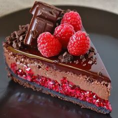 a piece of chocolate cake with raspberries on top