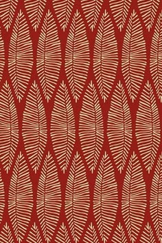 a red and white pattern with leaves on it