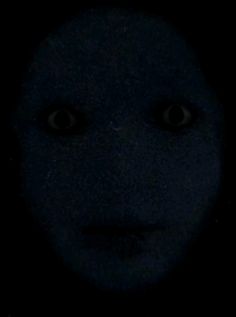 an evil looking face in the dark