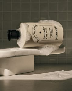 a bottle of soap sitting on top of a sink