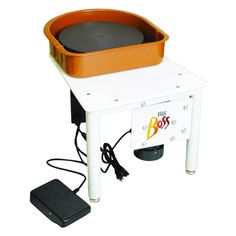 an orange and white table with a big pot on it's legs next to a charger