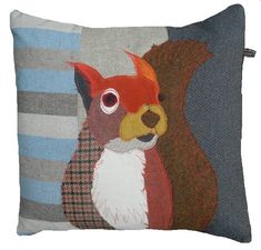 a pillow with a red squirrel on it