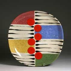 a multicolored plate with circles and dots on it