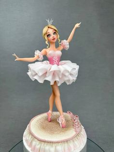 there is a figurine that has a ballerina figure on top of it