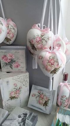 there are many heart shaped decorations hanging from the wall next to pictures and other items