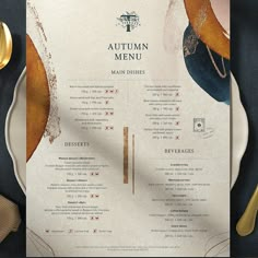 an autumn menu is displayed on a plate with gold spoons and utensils