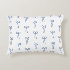 a white pillow with blue bows on it