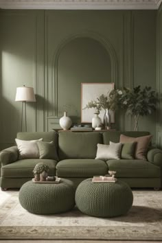 a living room with green walls and furniture in the corner, including a large round ottoman