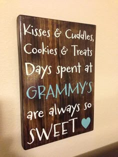 a wooden sign that reads kisses and cuddles cookies and treats days spent at granny's are always so sweet