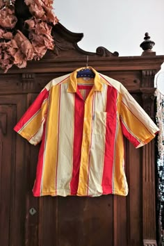 Beautiful Vintage short sleeve shirt. Comfortable cotton fabric with bold stripes pattern in red, white and yellow. Generous cut, button down, one breast pocket. Brand label tag on the pocket. Made in Italy! Looks great oversized with cut off jeans and sneakers. BRAND: Checker ERA: 1990s, 2000s COLOR: Red, white, yellow, grey Fabric: Fabric tag not readable anymore, it's cotton SIZE: Vintage size L -  please check the measurements below for reference MEASUREMENTS: Pit to pit 63cm, total length w Colourful Button Up Shirts, Red And Yellow Outfit Men, Striped Cotton Camp Shirt With Camp Collar, Summer Cotton Shirt With Vertical Stripes, Cotton Summer Shirt With Vertical Stripes, Cotton Camp Collar Top With Vertical Stripes, Cotton Shirt With Vertical Stripes For Summer, Cotton Top With Vertical Stripes And Camp Collar, Summer Shirt With Striped Camp Collar