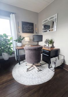 a chair sitting on top of a wooden floor in front of a desk with a computer