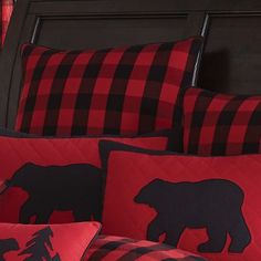 red and black plaid bedding with bear silhouettes on the pillowcase, along with matching pillows