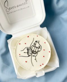 a cookie in a box with a drawing on it