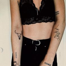 a woman with tattoos on her arms and chest