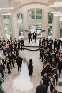 the bride and groom are standing in front of their guests at this wedding ceremony,