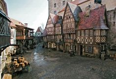 an old european village with cobblestones and lots of clay pots on the ground